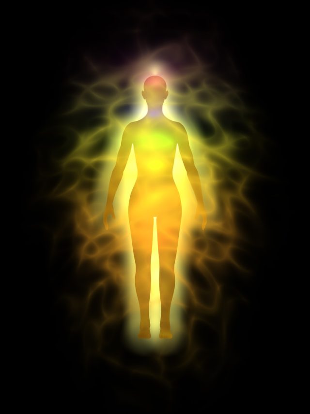 the human body energy fields displayed in golden light extending out from the body and surrounding the body
