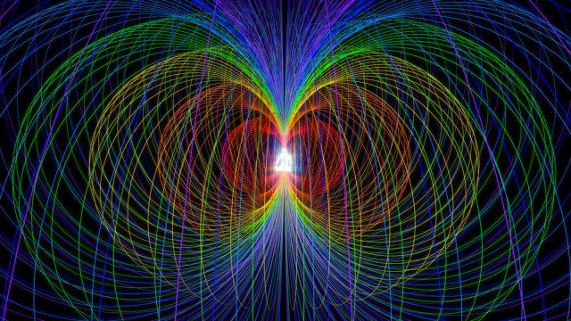 electromagnetic fields in an abstract sketch of two large spirrals facing and touching each other, both identical with colors of red, yellow and blues