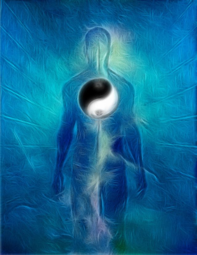 blue light of a human being full figure with the symbol of Yin and Yang in the middle, the heart center field
