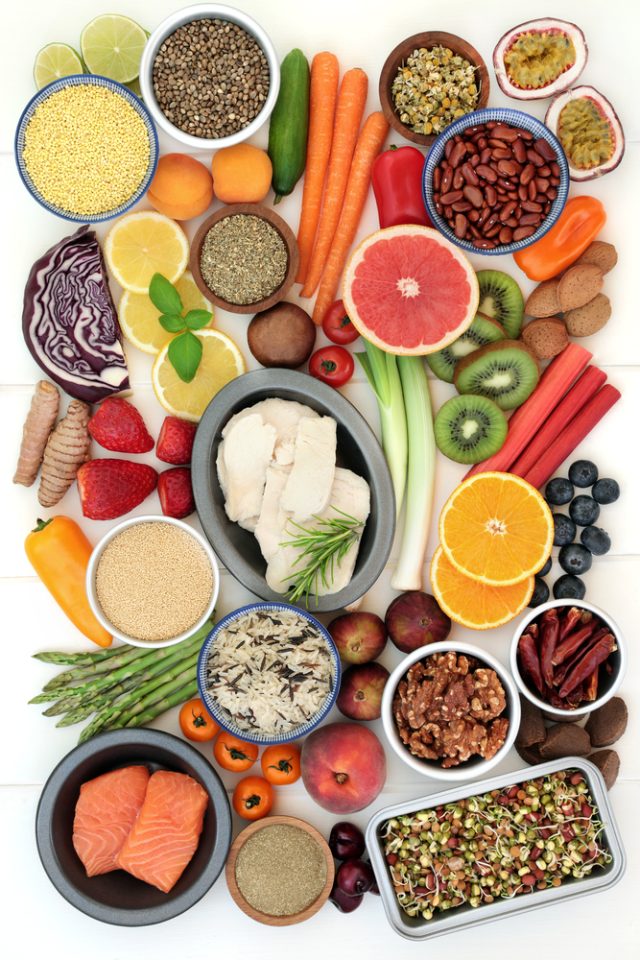 Healthy diet food for weight loss including vegetables, fruit, meat, fish, seeds, grain, spice and herbs used to suppress appetite with foods high in dietary fibre, antioxidants, vitamins and anthocyanins. Top view.